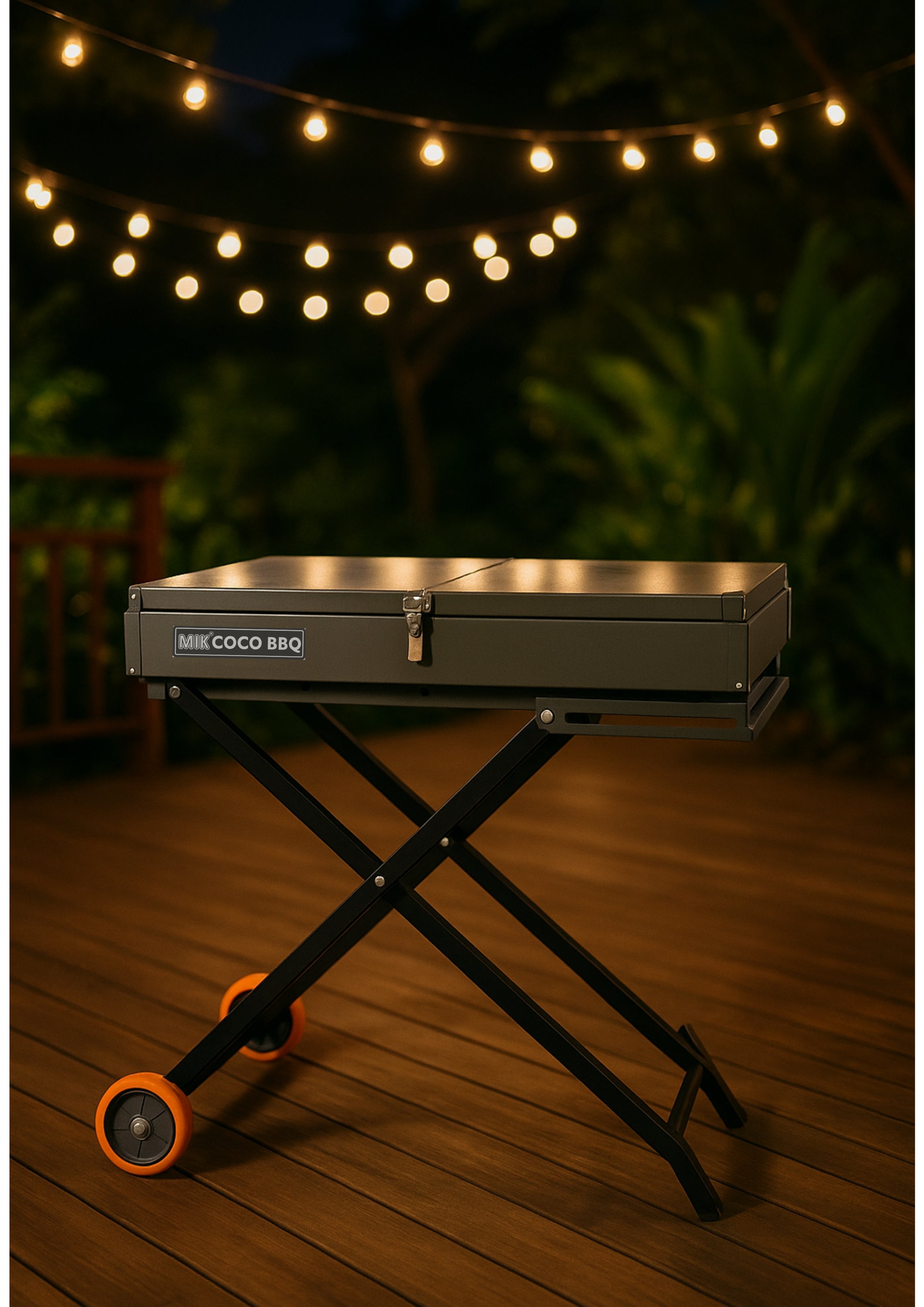 Portable grill on a stand with 'MKE COCO BBQ' branding, set against a dark background with string lights.